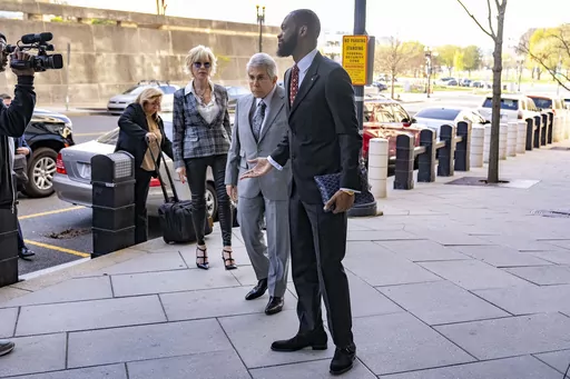 Prakazrel "Pras" Michel, a member of the 1990s hip-hop group the Fugees, accompanied by defense lawyer David Kenner, center left, arrives at federal court for his trial in an alleged campaign finance conspiracy, Monday, April 3, 2023, in Washington. (AP Photo/Andrew Harnik)