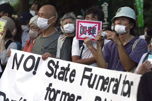 People protest outside Diet against the state paying for Japan's former Prime Minister Shinzo Abe's funeral in Tokyo on Aug. 31, 2022. A rare state funeral Tuesday, Sept. 27 for the former prime minister who was assassinated in July, has split Japan. (AP Photo/Eugene Hoshiko, File)