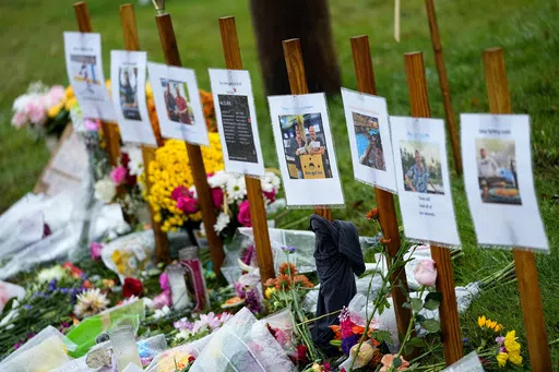 Rain soaked memorials for those who died in a mass shooting sit along the roadside by Schemengees Bar & Grille, Oct. 30, 2023, in Lewiston, Maine. Maine's Democratic-led Legislature gave final approval to legislation imposing new restrictions on guns before adjourning Thursday, April 18, 2024. (AP Photo/Matt York, File)