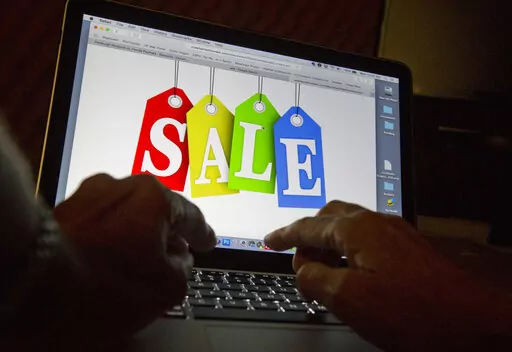 In this Dec. 12, 2016, photo, a person searches the internet for sales, in Miami. Days after flocking to stores on Black Friday, consumers are turning online for Cyber Monday to score more discounts on gifts and other items that have ballooned in price because of high inflation. Adobe Analytics, which tracks transactions for top online retailers, forecasts Cyber Monday will remain the year’s biggest online shopping day and rake in up to $11.6 billion in sales. (AP Photo/Wilfredo Lee)