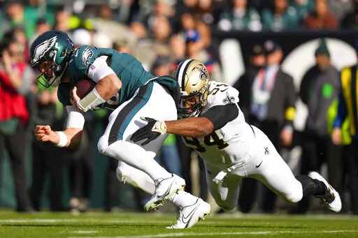 Philadelphia Eagles quarterback Gardner Minshew is tackled by New Orleans Saints defensive end Cameron Jordan (94) in the first half of an NFL football game in Philadelphia, Sunday, Jan. 1, 2023. (AP Photo/Matt Slocum)