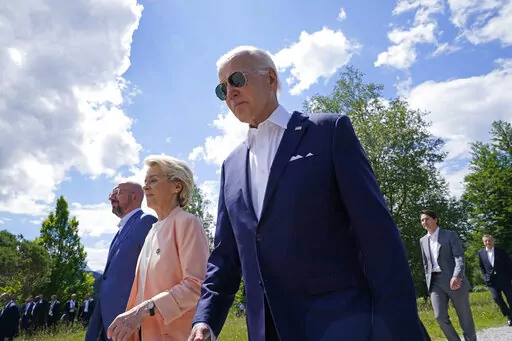 President Joe Biden, right, walks with European Commission President Ursula von der Leyen, center, and European Council President Charles Michel, left, as they head to a family photo with the G7 leaders at the G7 Summit in Elmau, Germany, Sunday, June 26, 2022. (AP Photo/Susan Walsh, Pool)