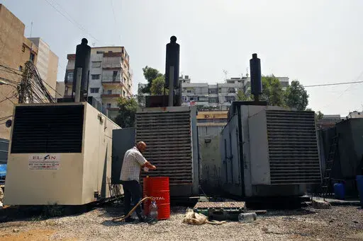 Mamdouh al-Amari refuels privately-owned diesel generators that provide power to homes and businesses, in the southern suburbs of Beirut, Lebanon, July 16, 2018. Internet services were disrupted in Lebanon Sunday, Jan. 16, 2022, because of diesel shortages, according to the state provider, adding another essential service to the list of casualties of the country’s snowballing economic crisis. (AP Photo/Bilal Hussein, File)