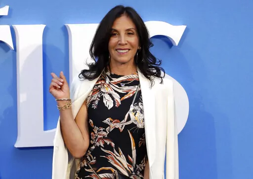 Olivia Harrison, widow of musician George Harrison, appears at the World premiere of the film "Eight days a week" in London on Sept. 15, 2016. Harrison released a book of poetry, "Came the Lightening: Twenty Poems for George." (AP Photo/Kirsty Wigglesworth, File)