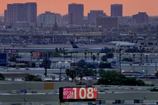 The unofficial temperature hits 108 degrees at dusk at Sky Harbor International Airport in Phoenix, on July 12, 2023. The U.S. last year saw the most heat waves since 1936, according to an Associated Press analysis of Centers for Disease Control and Prevention data. (AP Photo/Matt York, File)