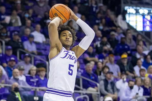 TCU forward Chuck O'Bannon Jr. (5) shoots a three pointer in the second half of an NCAA college basketball game against in Fort Worth, Texas, Saturday, Jan. 29, 2022. O’Bannon scored 16 of his career-high 19 points after halftime and TCU held on to beat slumping 19th-ranked LSU 77-68. (AP Photo/Gareth Patterson)