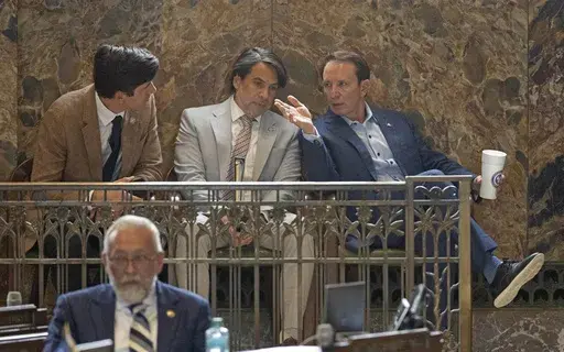 Louisiana Governor Jeff Landry, from right, speaks with his Deputy Chief of Staff, Legislative Affairs Lance Maxwell and legislative liaison Richard Brazan on the House floor during a special legislative session, Tuesday, Nov. 12, 2024, at the Louisiana State Capitol in Baton Rouge, La. (Hilary Scheinuk/The Advocate via AP)