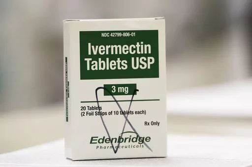 FILE -A box of ivermectin is shown in a pharmacy as pharmacists work in the background, Thursday, Sept. 9, 2021, in Ga. A federal appeals court Friday, Sept. 1, 2023 revived a lawsuit by three doctors who say the Food and Drug Administration overstepped its authority in a campaign against treating COVID-19 with the anti-parasite drug ivermectin(AP Photo/Mike Stewart, File)
