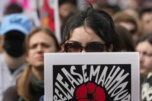 A person holds a sign in support of detained Palestinian activist Mahmoud Khalil while protesting the Trump administration at the University of California, Berkeley campus Wednesday, March 19, 2025, in Berkeley, Calif. (AP Photo/Godofredo A. Vásquez)