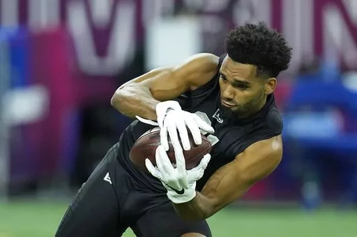 Ohio State wide receiver Chris Olave runs a drill during the NFL football scouting combine, Thursday, March 3, 2022, in Indianapolis. Olave is a possible first round pick in the NFL Draft. (AP Photo/Darron Cummings, File)