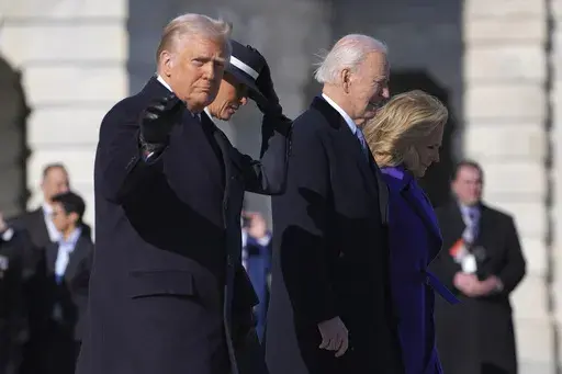 President Donald Trump, from left, gestures as he walks with first lady Melania Trump to send off former President Joe Biden and Jill Biden to board a Marine helicopter en route to Joint Base Andrews after the 60th Presidential Inauguration, Monday, Jan. 20, 2025, at the U.S. Capitol in Washington. (AP Photo/Evan Vucci)
