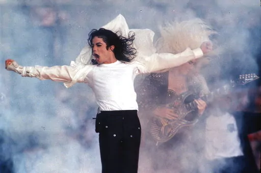 This Feb. 1, 1993 file photo shows Pop superstar Michael Jackson performing during the halftime show at the Super Bowl in Pasadena, Calif. A biopic about Jackson is in the works from Oscar-winning “Bohemian Rhapsody” producer Graham King and “Gladiator” screenwriter John Logan. Lionsgate will handle the worldwide distribution of the film, the studio’s chair Joe Drake said Monday.  (AP Photo/Rusty Kennedy, file)