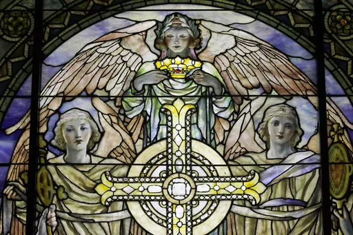 A detail of "The Righteous Shall Receive a Crown of Glory," Brainard Memorial Window for Methodist Church, Waterville, New York, ca. 1901 is photographed while on display at the "Louis C. Tiffany and the Art of Devotion" exhibit at the Museum of Biblical Art in New York on Thursday, Oct. 25 2012. About 7 in 10 U.S. adults say they believe in angels, according to a new poll released on Saturday, July 29, 2023, by The Associated Press-NORC Center for Public Affairs Research. (AP Photo/Mary Altaffe