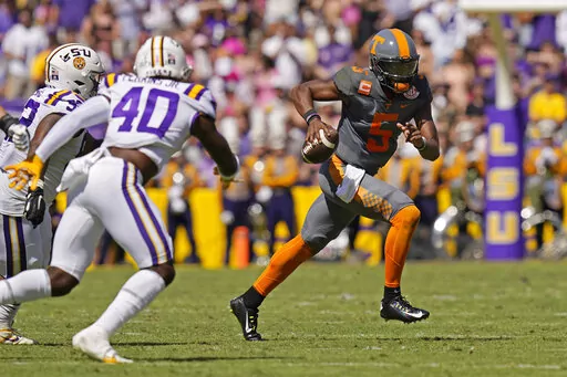 Tennessee quarterback Hendon Hooker (5) carries against LSU linebacker Harold Perkins Jr. (40) in the first half of an NCAA college football game in Baton Rouge, La., Saturday, Oct. 8, 2022. (AP Photo/Gerald Herbert)