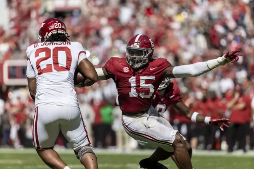 Alabama linebacker Dallas Turner (15) pursues Arkansas running back Dominique Johnson (20) during the second half of an NCAA college football game, Saturday, Oct. 14, 2023, in Tuscaloosa, Ala. Turner has been selected to The Associated Press midseason All-America team, Wednesday, Oct. 18, 2023.(AP Photo/Vasha Hunt, File)