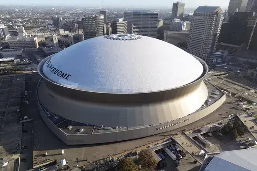 An aerial overall exterior general view of Caesars Superdome with the New Orleans skyline in the background is seen in New Orleans, Dec. 15, 2024. (AP Photo/Tyler Kaufman, File)
