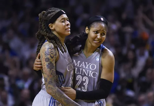 Minnesota Lynx guard Seimone Augustus (33) and forward Maya Moore (23) embrace after Game 5 of the team's WNBA Finals against the Los Angeles Sparks, Oct. 4, 2017 in Minneapolis. Moore and Augustus headline the 2024 Women's Basketball Hall of Fame class that was announced Thursday night, Nov. 30. The pair won four WNBA championships with the Lynx and helped the U.S. to Olympic gold medals in 2012 and 2016. Augustus was also part of the 2008 Olympic team that won gold. (Aaron Lavinsky/Star Tribun