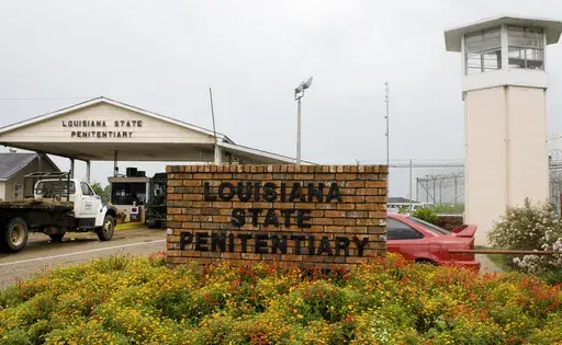 Vehicles enter at the main security gate at Louisiana State Penitentiary in Angola, La., Aug. 5, 2008. (AP Photo/Judi Bottoni, File)
