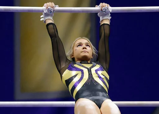 FILE -LSU gymnast Olivia Dunne competes during an NCAA gymnastics meet against Arkansas on Friday, Jan. 8, 2021 in Baton Rouge, La. LSU gymnast Olivia Dunne's endorsement of an artificial intelligence essay-writing product is raising questions about whether college athletic programs should provide clearer ethical guidelines for (AP Photo/Tyler Kaufman, File)