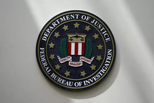An FBI seal is seen on a wall on Aug. 10, 2022, in Omaha, Neb. The FBI says scammers stole more than $3.4 billion from older Americans last year. An FBI report released Tuesday shows a rise in losses through increasingly sophisticated tactics to trick the vulnerable into giving up their life savings. (AP Photo/Charlie Neibergall, File)