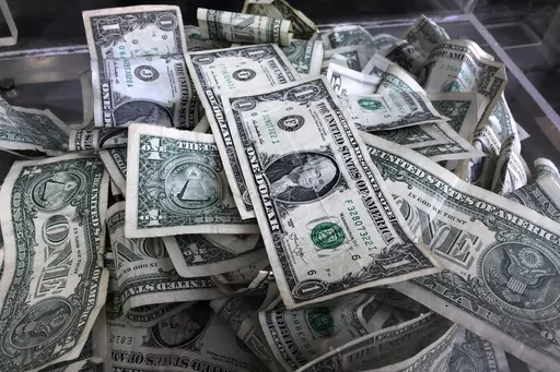 A tip box is filled with U.S. currency in New York, April 3, 2019. Taking on some degree of risk is a healthy part of making financial decisions, but it’s not always comfortable. Consider building up your emergency savings fund to help provide a buffer in case events don’t go as planned. (AP Photo/Mark Lennihan, File)