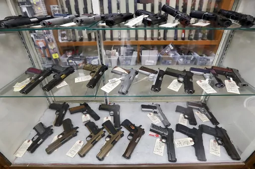 Semi-automatic handguns are displayed at shop in New Castle, Pa., March 25, 2020. A Biden administration rule requiring registration of stabilizing braces on handguns is unlikely to survive a legal challenge, a federal appeals court panel said Tuesday, Aug. 1, 2023, as it extended an order allowing a gun dealer and others challenging the regulation to keep owning, buying and selling the devices without registering them. (AP Photo/Keith Srakocic, File)