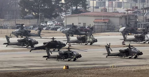 U.S. Army Apache helicopters take off at Camp Humphreys in Pyeongtaek, South Korea, Monday, March 4, 2024. North Korea called the ongoing South Korean-U.S. military drills a plot to invade the country, as it threatened Tuesday to take unspecified "responsible" military steps in response. (Kwon June-woo/Yonhap via AP)