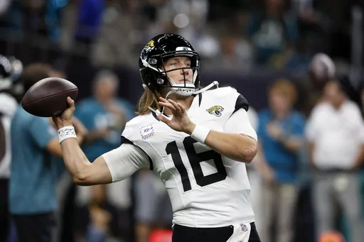 Jacksonville Jaguars quarterback Trevor Lawrence (16) warms before an NFL football game against the New Orleans Saints in New Orleans, Thursday, Oct. 19, 2023. (AP Photo/Butch Dill)