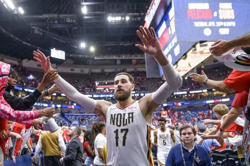New Orleans Pelicans center Jonas Valanciunas (17) is congratulated by fans after the Pelicans 118-103 victory against the Phoenix Suns in Game 4 of an NBA basketball first-round playoff series in New Orleans, Sunday, April 24, 2022. (AP Photo/Matthew Hinton)