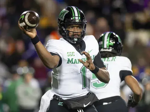 Marshall quarterback Braylon Braxton (1) fires off a pass during the first half of an NCAA college football game against James Madison in Harrisonburg, Va., Saturday, Nov. 30, 2024. (Daniel Lin/Daily News-Record via AP)