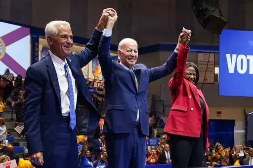 President Joe Biden is joined on stage by Florida gubernatorial candidate Rep. Charlie Crist, D-Fla., left, and Senate candidate Rep. Val Demings, D-Fla., during a campaign rally at Florida Memorial University, Tuesday, Nov. 1, 2022, in Miami Gardens, Fla. (AP Photo/Evan Vucci)