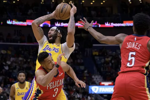 Los Angeles Lakers forward Anthony Davis (3) shoots against New Orleans Pelicans guard CJ McCollum (3) in the first half of an NBA basketball game in New Orleans, Tuesday, March 14, 2023. (AP Photo/Matthew Hinton)