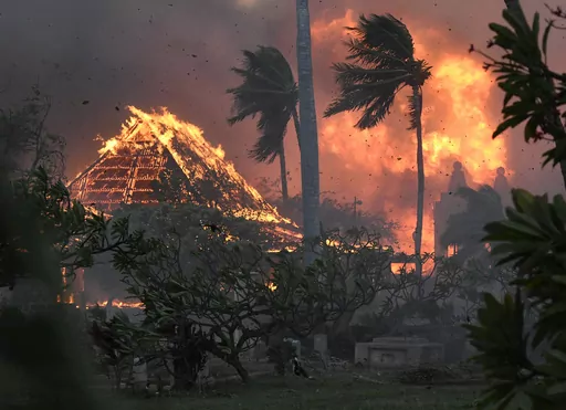 The hall of historic Waiola Church in Lahaina and nearby Lahaina Hongwanji Mission are engulfed in flames along Wainee Street, Tuesday, Aug. 8, 2023, in Lahaina, Hawaii. (Matthew Thayer/The Maui News via AP, File)