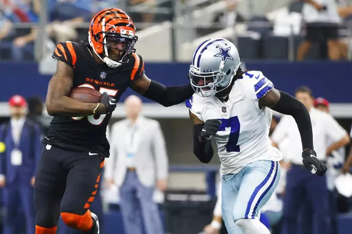Cincinnati Bengals wide receiver Tee Higgins (85) makes a first down reception as Dallas Cowboys cornerback Trevon Diggs (7) closes in during the second half of an NFL football game Sunday, Sept. 18, 2022, in Arlington, Tx. (AP Photo/Michael Ainsworth)