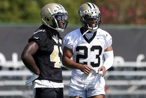 New Orleans Saints running back Alvin Kamara (41) and cornerback Marshon Lattimore (23) talk during NFL football practice in Metairie, La., Thursday, July 26, 2018. Both Lattimore and Kamara skipped voluntary practices this week. (AP Photo/Jonathan Bachman, File)