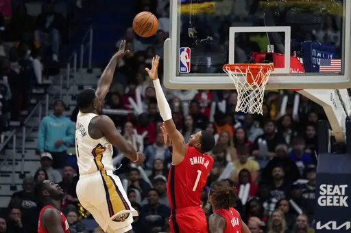 New Orleans Pelicans forward Zion Williamson (1) shoots over Houston Rockets forward Jabari Smith Jr. (1) in the second half of an NBA basketball game in New Orleans, Saturday, Nov. 12, 2022. The Pelicans won 119-106. (AP Photo/Gerald Herbert)