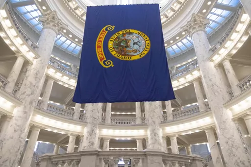 The Idaho state flag hangs in the State Capitol in Boise, Idaho, Jan. 9, 2023. The Idaho Senate is expected to take a final vote on Monday, March 18, 2024, on a bill that would prohibit transgender and nonbinary Idahoans enrolled in Medicaid, or state employees enrolled in the state's insurance plan, from obtaining gender-affirming care. (AP Photo/Kyle Green, File)