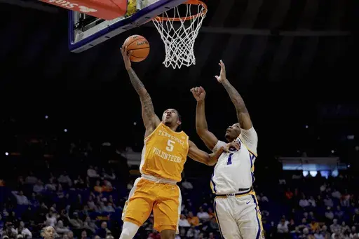 Tennessee guard Zakai Zeigler (5) shoots against LSU guard Jordan Sears (1) during the first half of an NCAA college basketball game in Baton Rouge, La., Tuesday, Feb. 25, 2025. (AP Photo/Matthew Hinton)