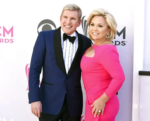 Todd Chrisley, left, and his wife, Julie Chrisley, pose for photos at the 52nd annual Academy of Country Music Awards on April 2, 2017, in Las Vegas. Todd and Julie Chrisley were driven by greed as they engaged in an extensive bank fraud scheme and then hid their wealth from tax authorities while flaunting their lavish lifestyle, federal prosecutors said, arguing the reality television stars should receive lengthy prison sentences. They were found guilty on federal charges in June and are set to