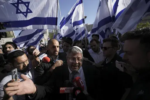 Israeli lawmaker Itamar Ben-Gvir, center, speaks to the media surrounded by right wing activists as they gather for a march in Jerusalem, April 20, 2022. Ben-Gvir visited Jerusalem’s most sensitive holy site Thursday, July 18, 2024, a move that could threaten the delicate Gaza cease-fire talks. (AP Photo/Ariel Schalit, File)