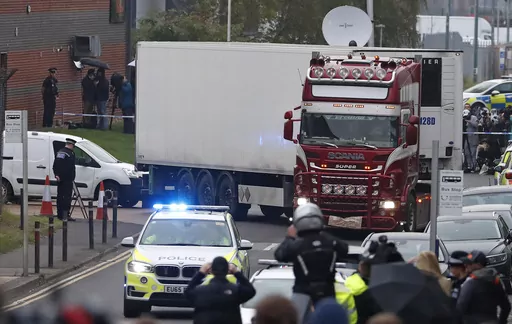 Police escort the truck, that was found to contain a large number of dead bodies, as they move it from an industrial estate in Thurrock, south England, Oct. 23, 2019. The final member convicted in a London court for a migrant smuggling ring that was responsible for the deaths of 39 Vietnamese immigrants who suffocated in a shipping container was sentenced Thursday Nov. 30, 2023. (AP Photo/Alastair Grant, File)