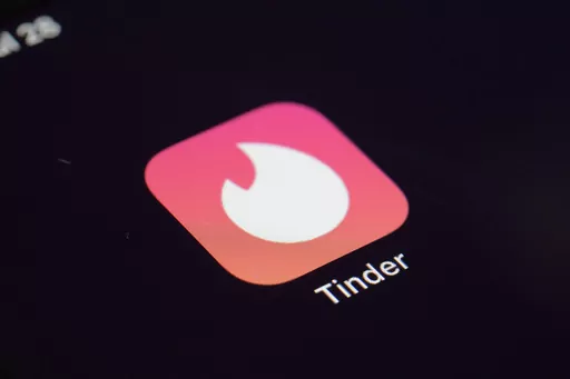The icon for the dating app Tinder appears on a device, July 28, 2020, in New York. Tinder, Hinge and other dating apps are designed with addictive features that encourage “compulsive” use, a proposed class action lawsuit against parent company Match Group claims. The lawsuit filed Wednesday, Feb. 14, 2024, says Match intentionally designs its dating platforms with game-like features that “lock users into a perpetual pay-to-play loop” prioritizing profit over promises to help users find 