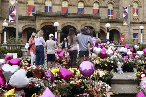 People look at the floral tribute at the Atkinson arts centre in Southport, England, Monday, Aug. 5, 2024 after three young girls were killed in a knife attack at a Taylor Swift-themed holiday club the week before. (AP Photo/Darren Staples, File)