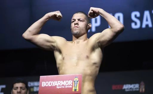 FILE -FILE - Welterweight fighter Nate Diaz poses on the scale during a ceremonial weigh-in for the UFC 279 mixed martial arts event on Sept. 9, 2022, in Las Vegas. Mixed martial arts fighter Nate Diaz turned himself in to police in New Orleans on Thursday, April 27, 2023, to face a battery charge arising from a weekend street brawl. (Steve Marcus/Las Vegas Sun via AP, File)