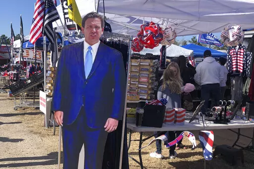 A cardboard cutout of Florida Gov. Ron DeSantis stands in the merchandise area outside former President Donald Trump's rally in Conroe, Texas, Saturday, Jan. 29, 2022. At Trump’s rally, there were signs of change. Next to the Trump hats, shirts and flags sat a collection of Ron “DeSantis 2024” bumper stickers. The vast majority of those interviewed at Trump’s rally enthusiastically cheered the prospect of another Trump run. But there were some who conceded that, perhaps, there might be a
