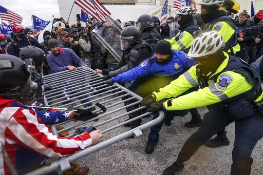 Rioters try to break through a police barrier at the Capitol in Washington on Jan. 6, 2021. News organizations are using sophisticated new technologies to transform the way they conduct investigations. Much of it is publicly available, or “open-source” material from mobile phones, satellite images and security cameras, but it also extends to computer modeling and artificial intelligence. A reporting form that barely existed a decade ago is becoming an important part of journalism's future. (