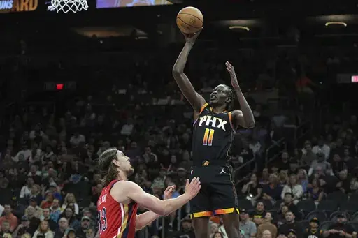 Phoenix Suns center Bol Bol (11) shoots over New Orleans Pelicans forward Kelly Olynyk during the first half of an NBA basketball game, Friday, Feb. 28, 2025, in Phoenix. (AP Photo/Rick Scuteri)