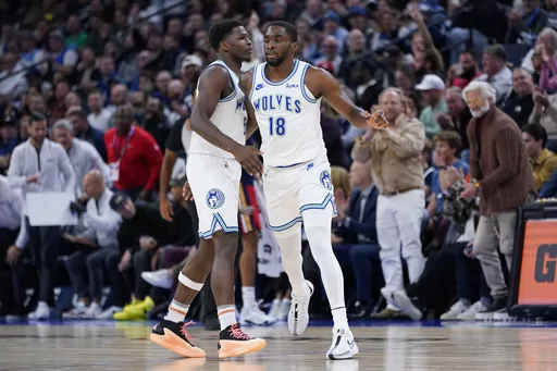 Minnesota Timberwolves guard Shake Milton (18) celebrates with guard Anthony Edwards (5) after making a basket during the first half of an NBA basketball game against the New Orleans Pelicans, Wednesday, Nov. 8, 2023, in Minneapolis. (AP Photo/Abbie Parr)
