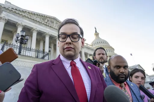 Rep. George Santos, R-N.Y., speaks to reporters outside the Capitol, as his top political aide Vish Burra, second from right, listens, after an effort to expel Santos from the House, in Washington, Wednesday, May 17, 2023. A man who briefly worked as an aide to Santos told House investigators Wednesday, May 31, that he got his job after sending a series of payments to Burra, Santos' director of operations. (AP Photo/J. Scott Applewhite, File)