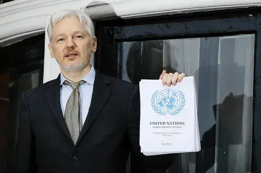 WikiLeaks founder Julian Assange speaks on the balcony of the Ecuadorean Embassy in London, Feb. 5, 2016. Assange will plead guilty to a felony charge in a deal with the U.S. Justice Department that will free him from prison and resolve a long-running legal saga over the publication of a trove of classified documents. (AP Photo/Kirsty Wigglesworth, File)